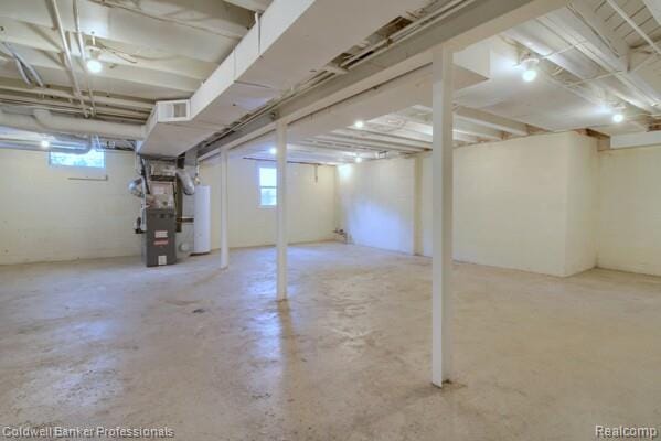 25811 Briarbank Ave, Southfield, MI 48033 - below grade area featuring plenty of natural light, heating unit, and water heater