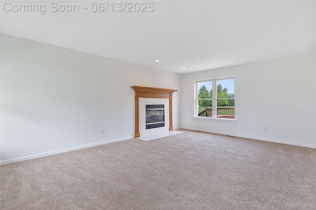12172 Rynn Rd, Emmett, MI 48022 - unfurnished living room with a tiled fireplace, carpet, baseboards, and recessed lighting