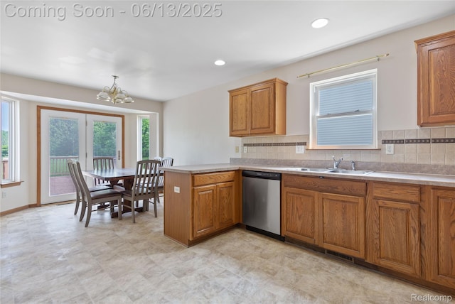 12172 Rynn Rd, Emmett, MI 48022 - kitchen featuring stainless steel dishwasher, a chandelier, brown cabinetry, a sink, and a peninsula
