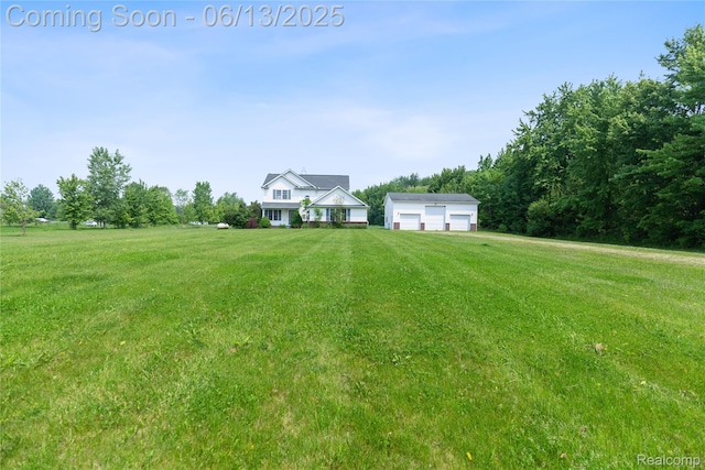 12172 Rynn Rd, Emmett, MI 48022 - view of green lawn with a detached garage