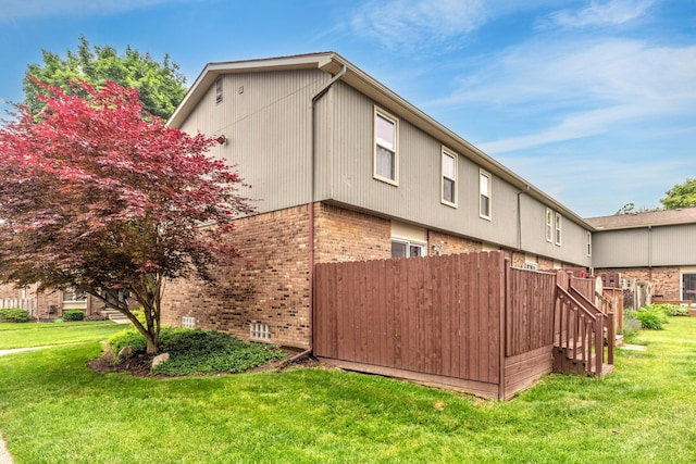 386 Hartman Ln, Saline, MI 48176 - view of side of property with brick siding and a lawn