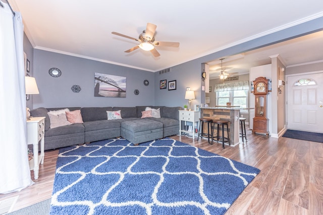 386 Hartman Ln, Saline, MI 48176 - living room featuring ceiling fan, wood finished floors, crown molding, and baseboards