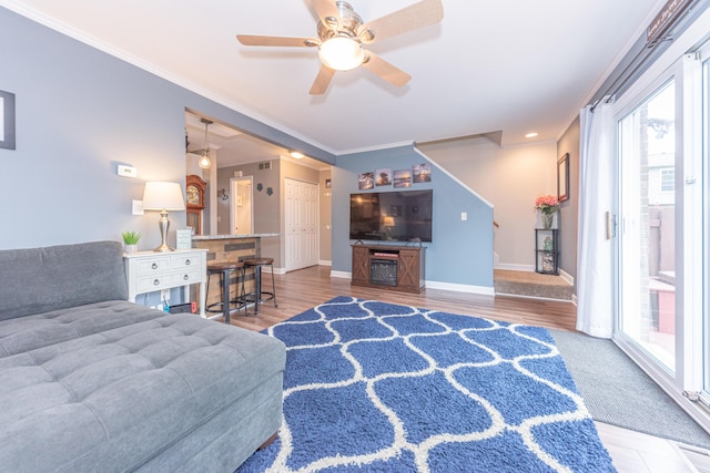 386 Hartman Ln, Saline, MI 48176 - living area with healthy amount of natural light, ceiling fan, baseboards, ornamental molding, and wood finished floors