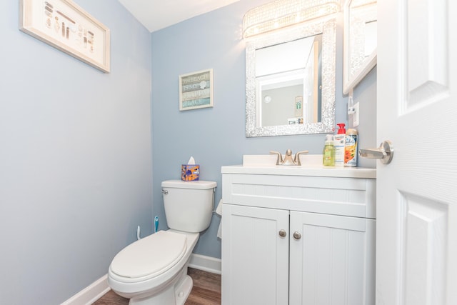 386 Hartman Ln, Saline, MI 48176 - half bath featuring vanity, baseboards, toilet, and wood finished floors