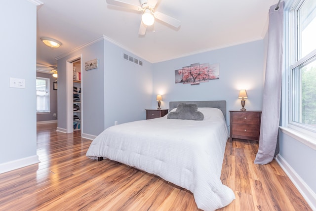 386 Hartman Ln, Saline, MI 48176 - bedroom with wood finished floors, baseboards, ornamental molding, and ceiling fan