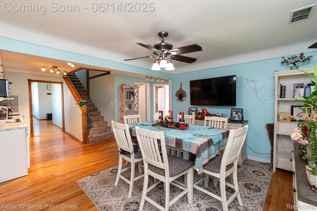 7359 Mckinley, Center Line, MI 48015 - dining room with light wood-style flooring, ceiling fan, and stairway