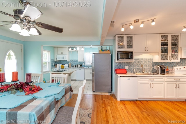 7359 Mckinley, Center Line, MI 48015 - kitchen with appliances with stainless steel finishes, light countertops, decorative backsplash, light wood-style flooring, and ceiling fan