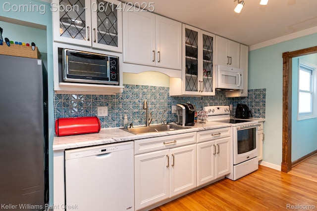 7359 Mckinley, Center Line, MI 48015 - kitchen featuring white appliances, light countertops, tasteful backsplash, and white cabinetry