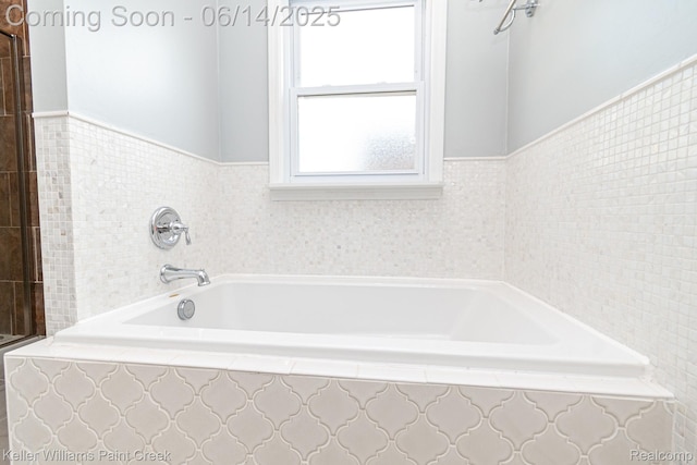 7359 Mckinley, Center Line, MI 48015 - bathroom with a bath, a wainscoted wall, and tile walls