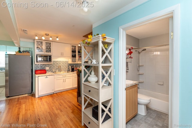 7359 Mckinley, Center Line, MI 48015 - kitchen featuring freestanding refrigerator, dishwasher, built in microwave, light countertops, and glass insert cabinets
