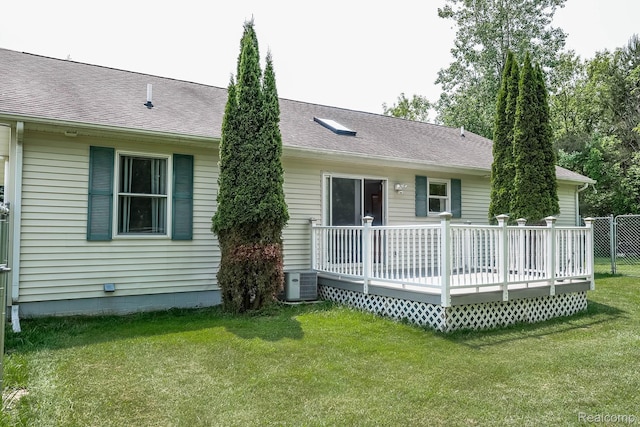 7448 Avoca Rd, Clyde, MI 48049 - rear view of property featuring a wooden deck, a yard, cooling unit, and roof with shingles