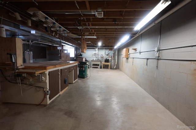 7448 Avoca Rd, Clyde, MI 48049 - basement featuring water heater, a workshop area, and concrete block wall