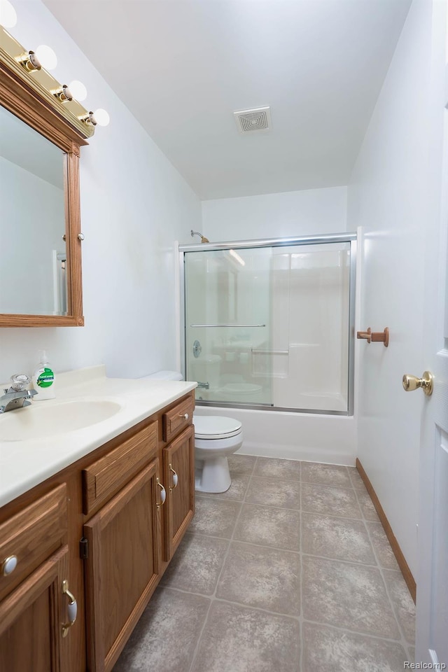 7448 Avoca Rd, Clyde, MI 48049 - bathroom with vanity, toilet, enclosed tub / shower combo, baseboards, and tile patterned flooring