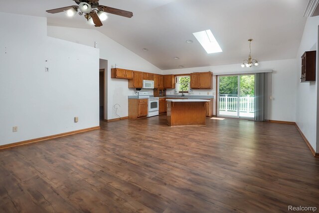 7448 Avoca Rd, Clyde, MI 48049 - kitchen featuring white appliances, open floor plan, a skylight, light countertops, and brown cabinets