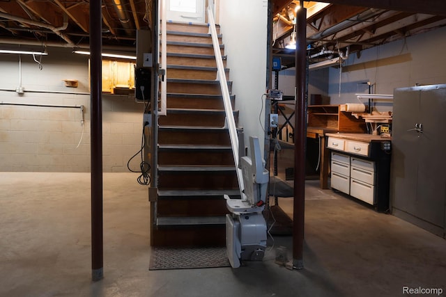 7448 Avoca Rd, Clyde, MI 48049 - unfinished basement featuring stairs and concrete block wall