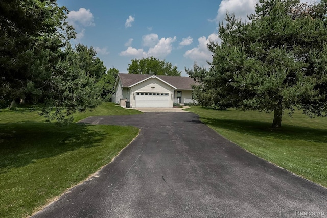 7448 Avoca Rd, Clyde, MI 48049 - view of front of property featuring asphalt driveway, a front lawn, and an attached garage