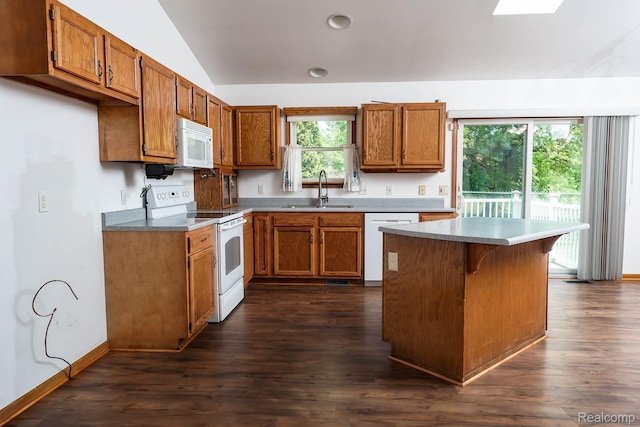 7448 Avoca Rd, Clyde, MI 48049 - kitchen with white appliances, a sink, brown cabinetry, lofted ceiling, and dark wood-type flooring