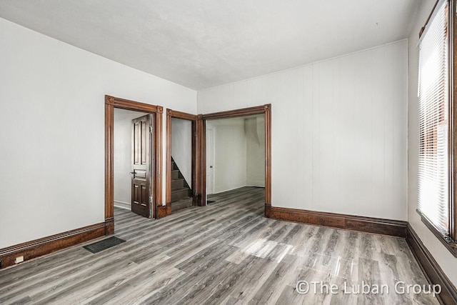 630 Prospect Ave NE, Grand Rapids, MI 49503 - unfurnished room with wood finished floors, stairway, and baseboards