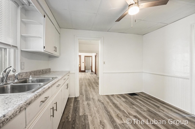 630 Prospect Ave NE, Grand Rapids, MI 49503 - kitchen with open shelves, a sink, white cabinetry, wood finished floors, and light countertops