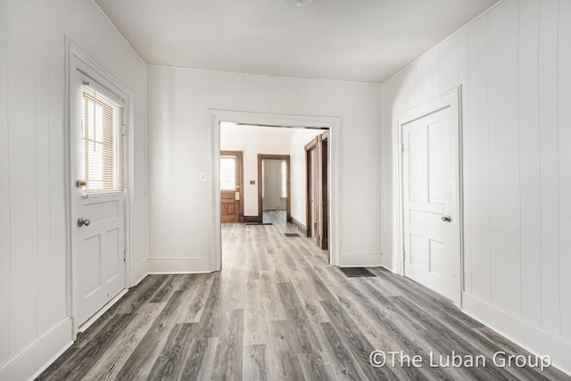 630 Prospect Ave NE, Grand Rapids, MI 49503 - corridor featuring wood finished floors, baseboards, and a decorative wall