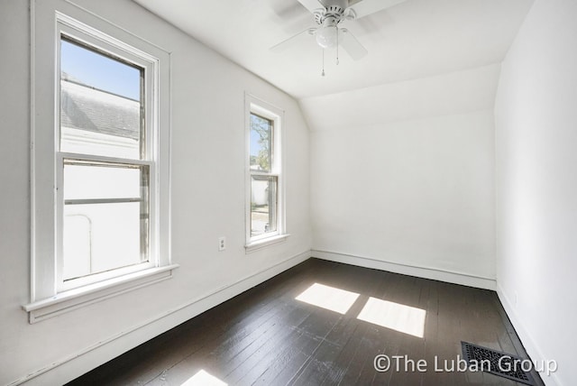 630 Prospect Ave NE, Grand Rapids, MI 49503 - unfurnished room with lofted ceiling, baseboards, dark wood-type flooring, and a ceiling fan