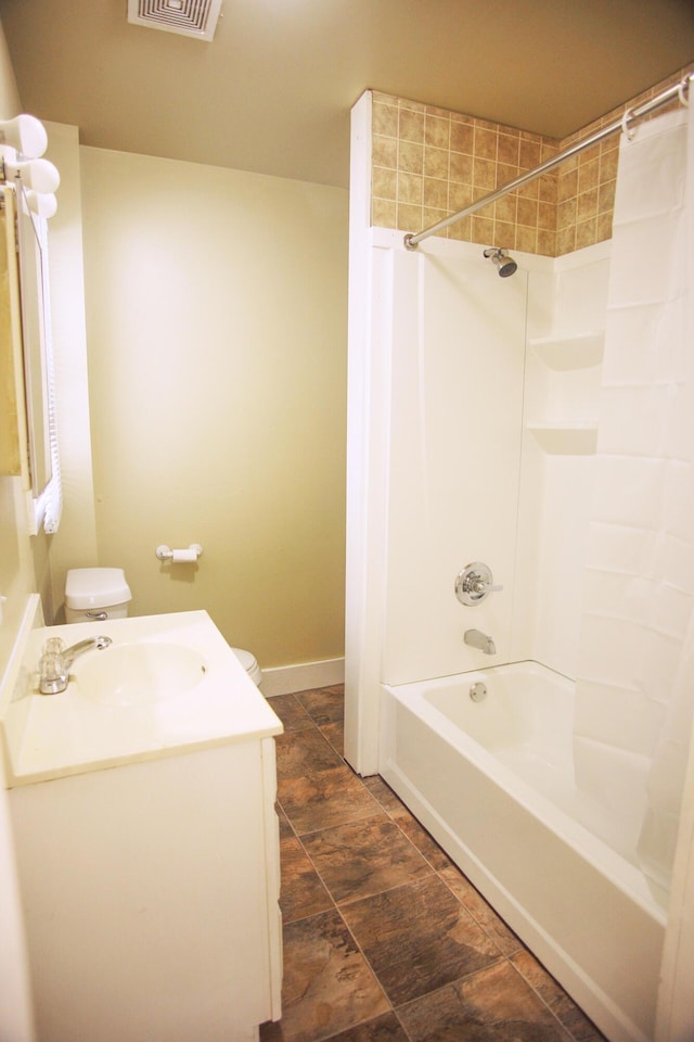 121 Houseman Ave NE, Grand Rapids, MI 49503 - bathroom featuring vanity, shower / bathtub combination, and toilet