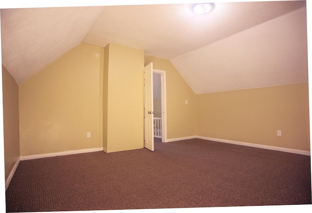 121 Houseman Ave NE, Grand Rapids, MI 49503 - bonus room featuring vaulted ceiling, dark carpet, and baseboards