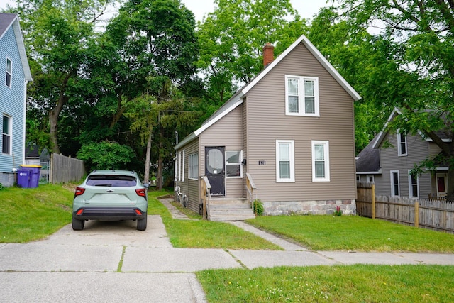 121 Houseman Ave NE, Grand Rapids, MI 49503 - view of front of house with a chimney and driveway