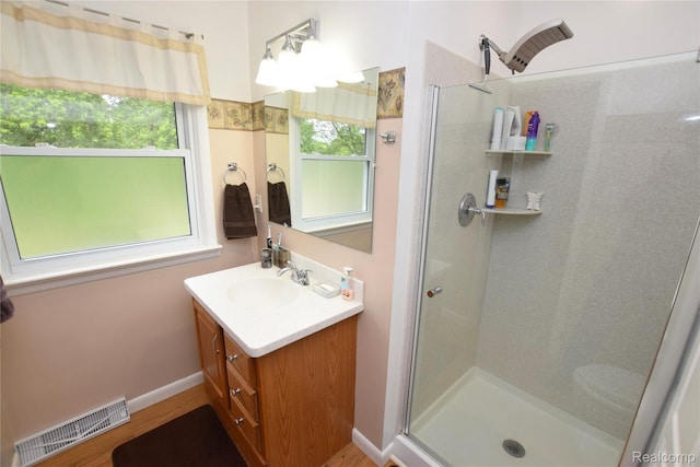 5483 Ameno Ln, Swartz Creek, MI 48473 - full bathroom featuring a shower with door, vanity, and wood finished floors