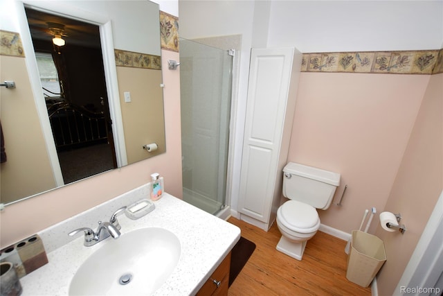 5483 Ameno Ln, Swartz Creek, MI 48473 - full bath featuring wood finished floors, a stall shower, vanity, and toilet
