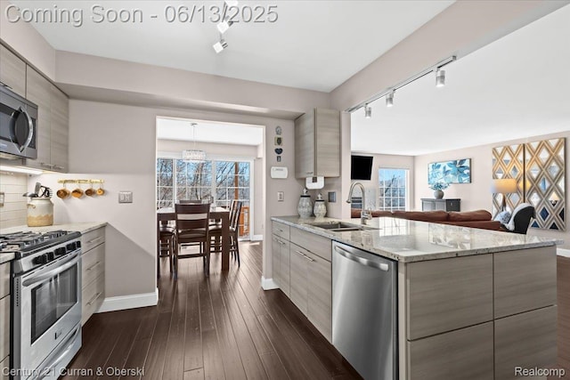619 Winwood Cir, Walled Lake, MI 48390 - kitchen with stainless steel appliances, rail lighting, modern cabinets, dark wood finished floors, and decorative backsplash