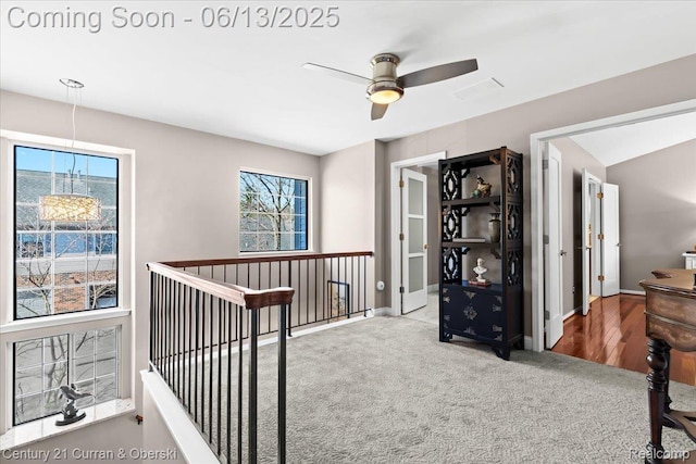 619 Winwood Cir, Walled Lake, MI 48390 - hall with plenty of natural light, carpet, and an upstairs landing
