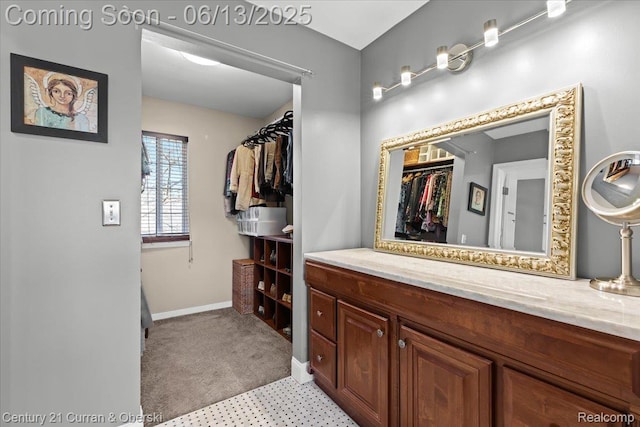 619 Winwood Cir, Walled Lake, MI 48390 - bathroom with a walk in closet and vanity