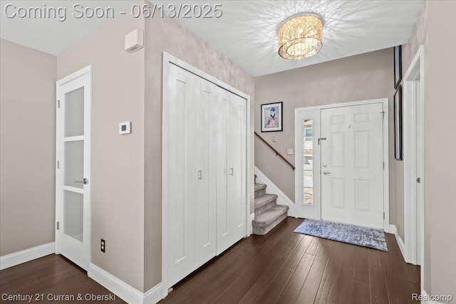 619 Winwood Cir, Walled Lake, MI 48390 - foyer entrance with dark wood-style flooring and stairway