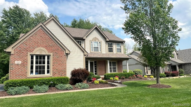 763 Chemung Forest Dr, Howell, MI 48843 - view of front of house featuring brick siding and a front yard