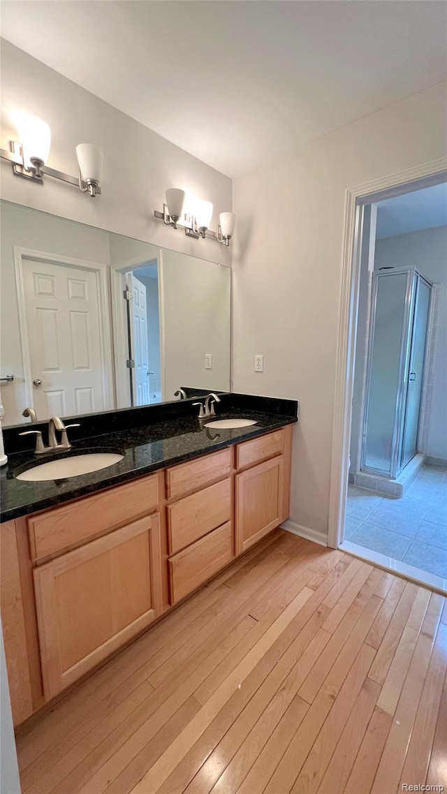 763 Chemung Forest Dr, Howell, MI 48843 - full bathroom featuring wood finished floors, double vanity, and a stall shower
