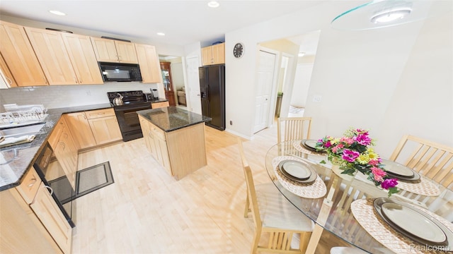 763 Chemung Forest Dr, Howell, MI 48843 - kitchen with black appliances, light brown cabinets, a center island, dark stone counters, and decorative backsplash