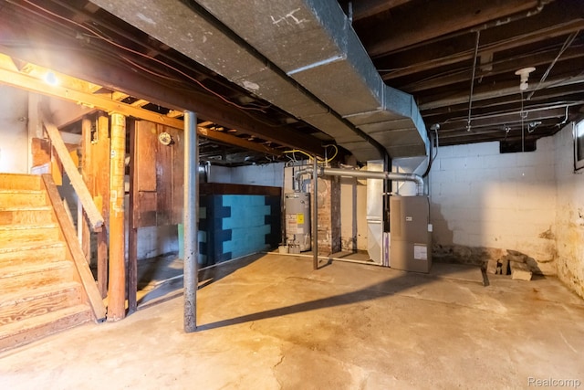 218 Clifford St, Lansing, MI 48912 - unfinished basement featuring water heater, stairs, and heating unit