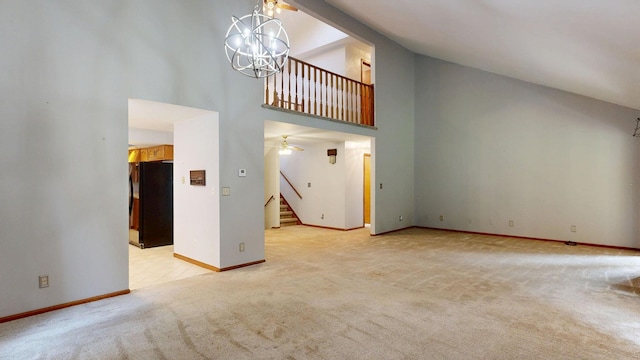 160 Wire Line Rd, Caro, MI 48723 - unfurnished living room featuring high vaulted ceiling, light colored carpet, stairway, baseboards, and a chandelier