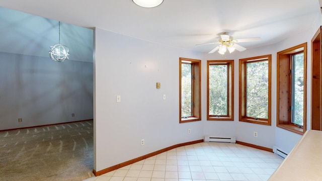 160 Wire Line Rd, Caro, MI 48723 - unfurnished dining area featuring a baseboard heating unit, ceiling fan, baseboards, and a chandelier