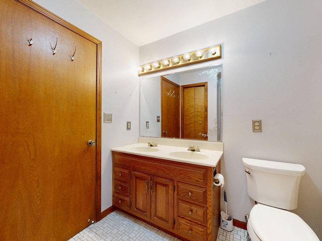 160 Wire Line Rd, Caro, MI 48723 - bathroom with toilet, double vanity, and baseboards
