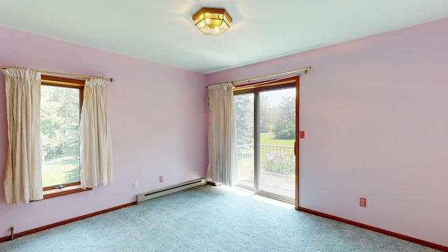 160 Wire Line Rd, Caro, MI 48723 - carpeted empty room featuring baseboard heating, plenty of natural light, and baseboards