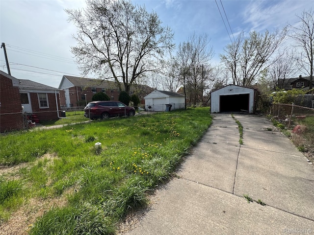 14952 Elmdale St, Detroit, MI 48213 - view of yard featuring a detached garage, an outdoor structure, and driveway