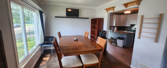1781 Davis St, Muskegon, MI 49441 - dining space featuring plenty of natural light, dark wood finished floors, and ornamental molding