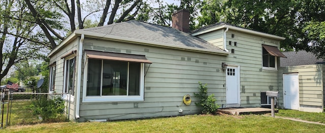 1781 Davis St, Muskegon, MI 49441 - view of side of property featuring a chimney and roof with shingles