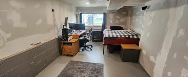 1781 Davis St, Muskegon, MI 49441 - bedroom featuring finished concrete flooring, concrete block wall, and a desk