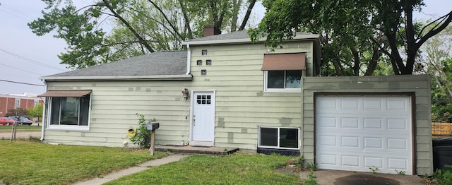 1781 Davis St, Muskegon, MI 49441 - rear view of property featuring a chimney, roof with shingles, and a yard