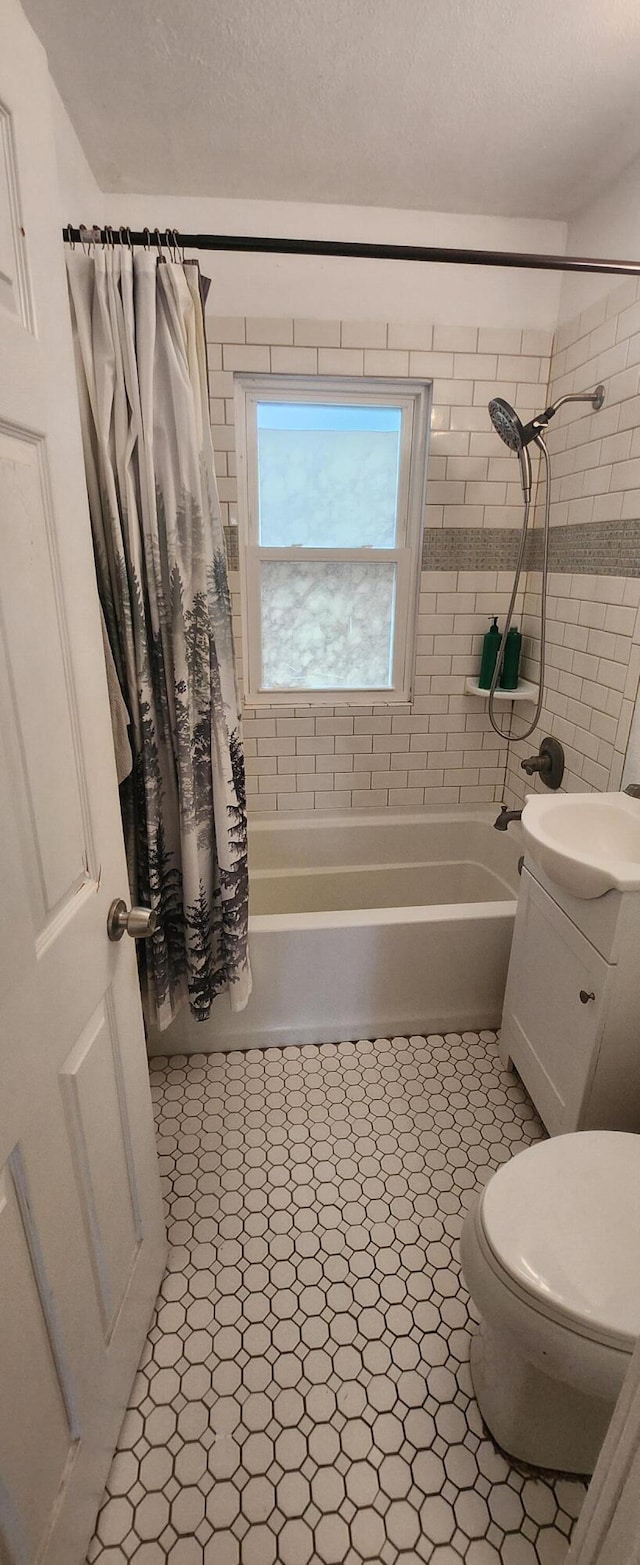 1781 Davis St, Muskegon, MI 49441 - bathroom with shower / bathtub combination with curtain, toilet, vanity, and a textured ceiling