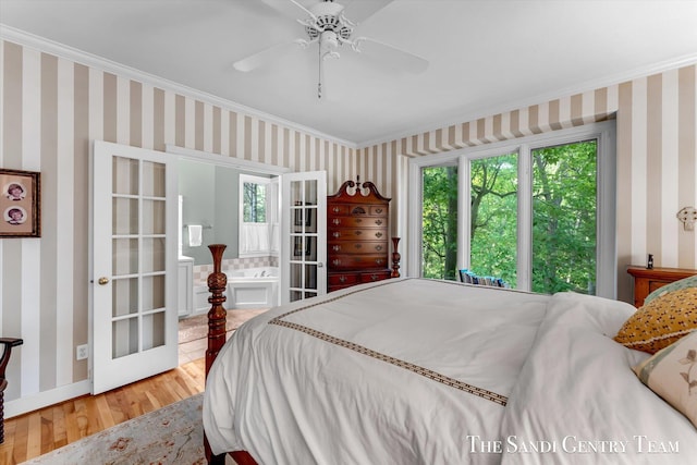8985 Lakeshore Dr, West Olive, MI 49460 - bedroom featuring wood finished floors, ornamental molding, wallpapered walls, a ceiling fan, and baseboards