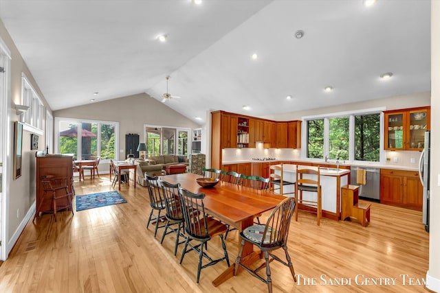 8985 Lakeshore Dr, West Olive, MI 49460 - dining area with light wood finished floors, vaulted ceiling, ceiling fan, recessed lighting, and baseboards